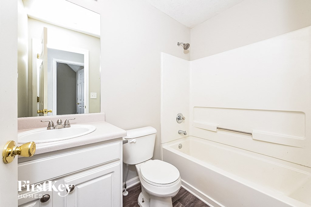 a bathroom with a sink toilet and bath tub