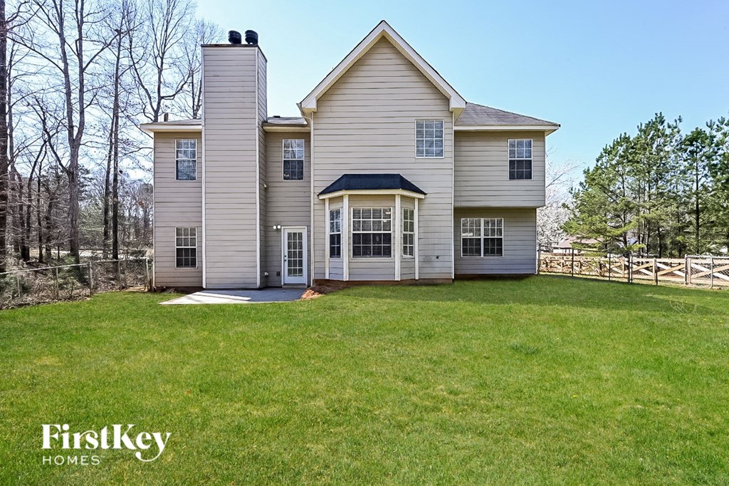 a white house with a yard in front of it