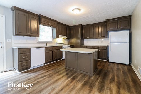 a kitchen with brown cabinets and white appliances