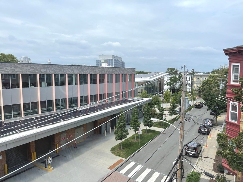 an overhead view of a city street with buildings and a bridge