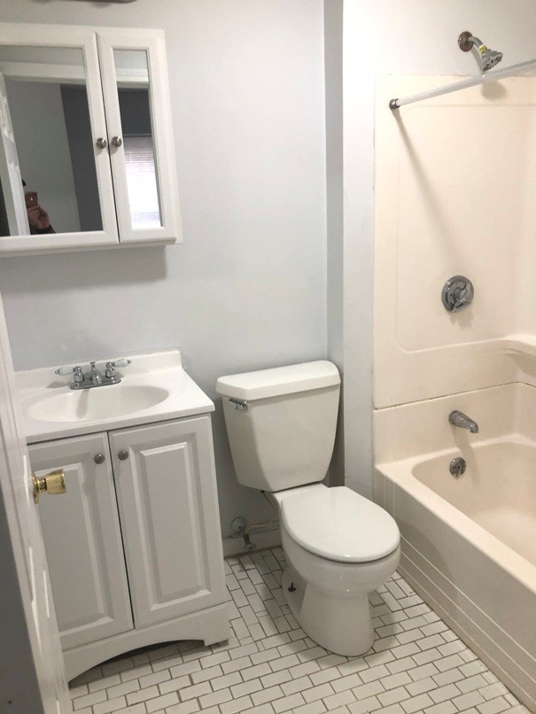 a bathroom with a toilet and a sink and a shower