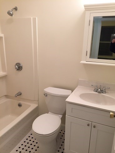 a bathroom with a toilet and a sink and a bath tub
