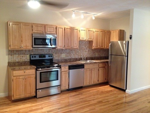 a kitchen with stainless steel appliances and wooden cabinets