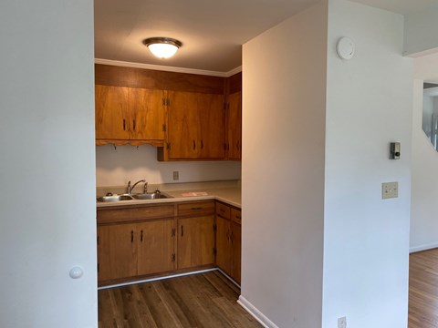 A kitchen with wooden cabinets and a white countertop.