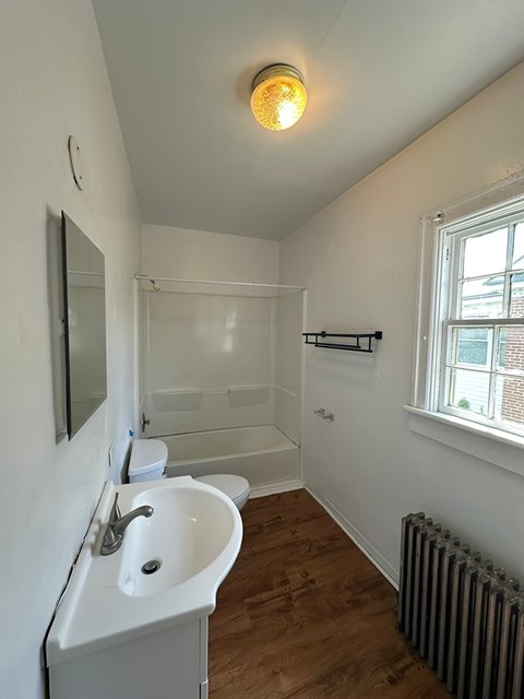 A white sink in a small bathroom.