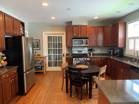 a kitchen with wooden cabinets and a black table