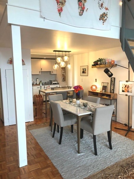 A dining room with a table set for four.