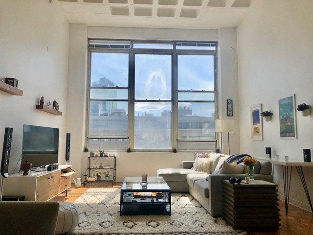 a living room with a couch and a large window