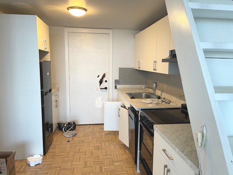 an empty kitchen with a stove and a sink