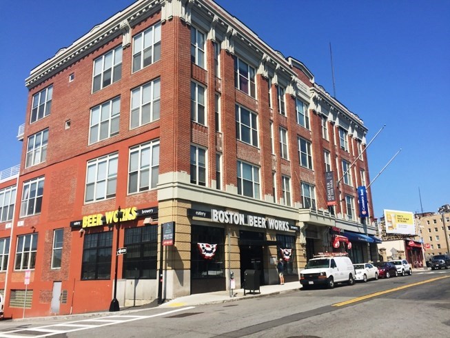 a large brick building on the corner of a street