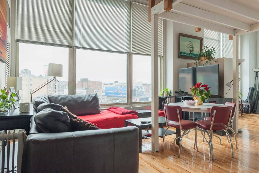 a living room with a couch and a table and a large window
