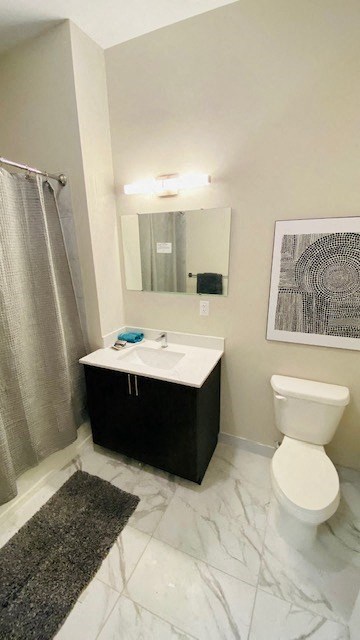 a bathroom with a toilet and a sink and a mirror