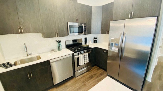 a kitchen with stainless steel appliances and a refrigerator