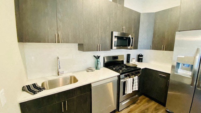 a kitchen with a stove and a sink and a refrigerator