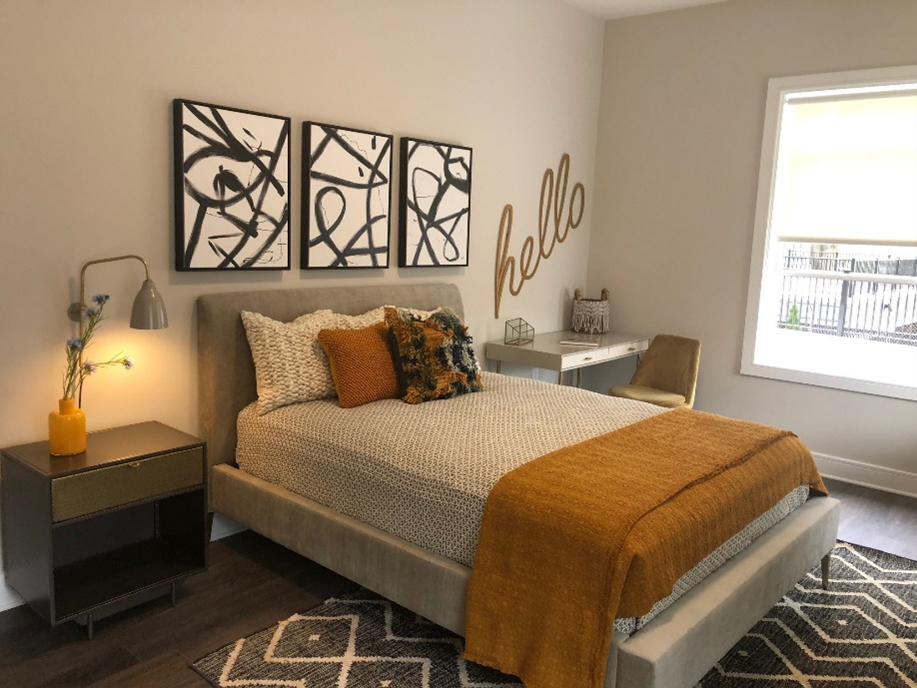 a bedroom with a bed and art on the wall