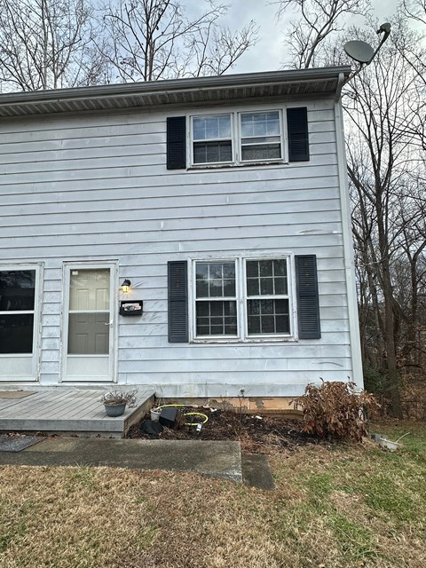 A house with a white door and black shutters.