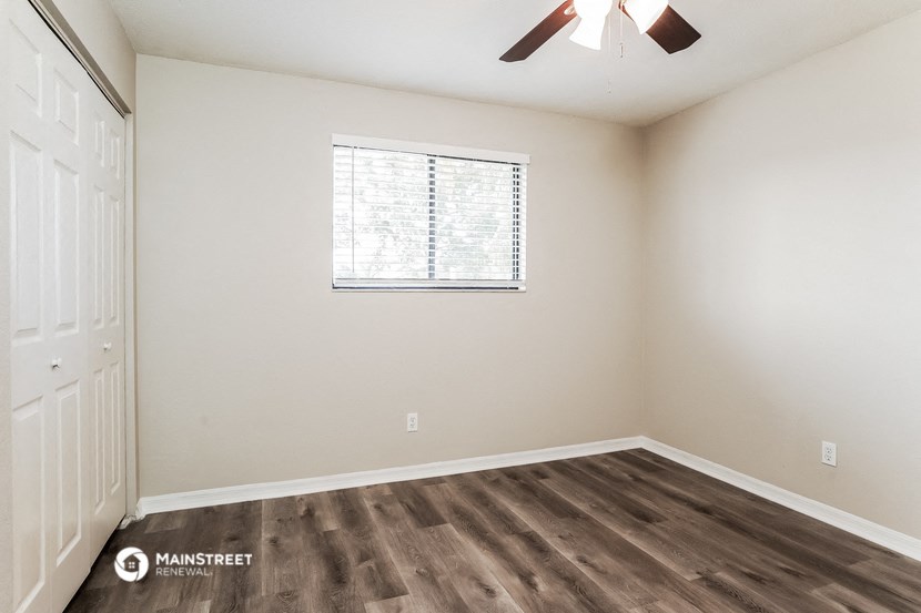 the bedroom of our studio apartment atrium with wood flooring and a window