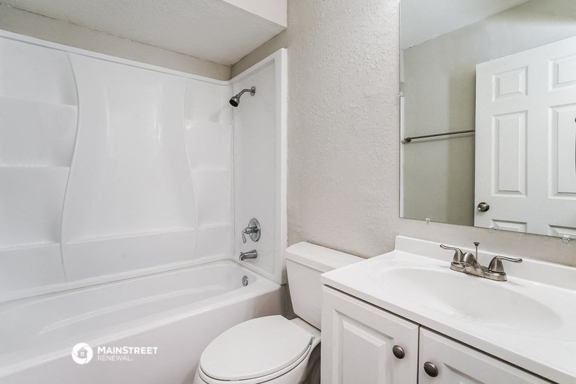 a bathroom with a sink toilet and a tub