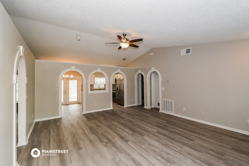 the living room is open to the dining room and kitchen