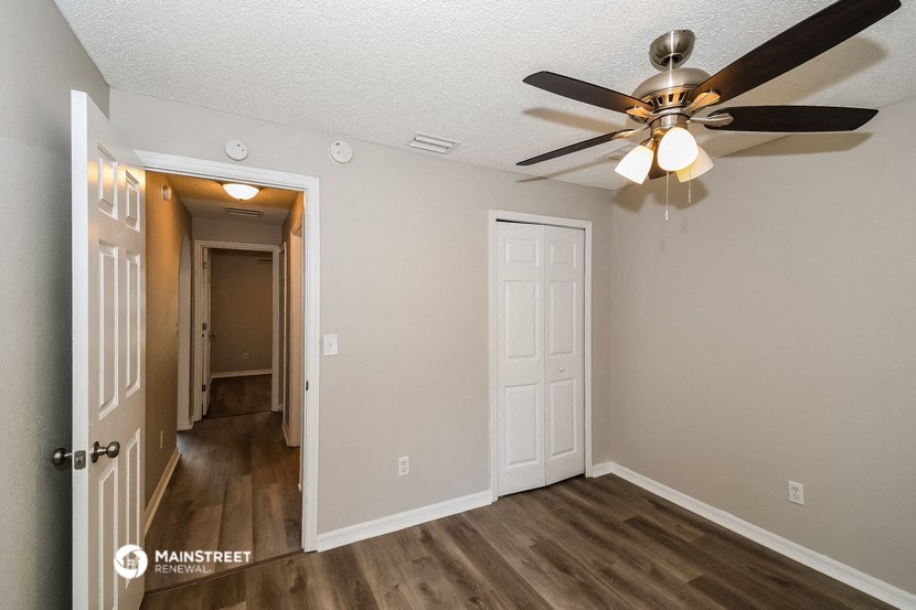 the living room of our studio apartment atrium with ceiling fan and door to hallway