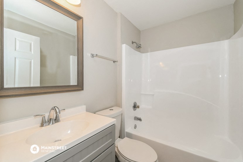 a bathroom with a sink and a shower and a toilet