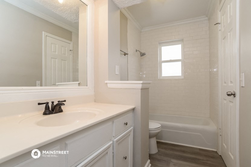a bathroom with a sink and a toilet and a bath tub