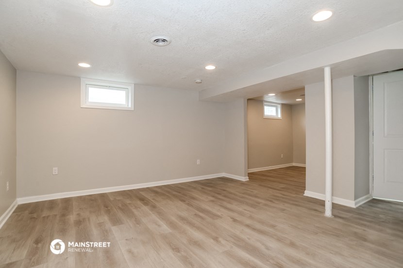 the spacious living room and dining room in this renovated home