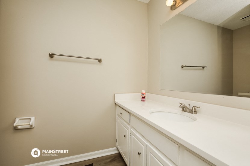 a white bathroom with a sink and a mirror