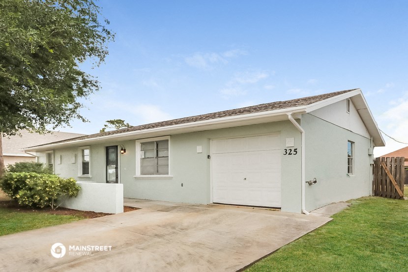 a white house with a driveway and a white garage door