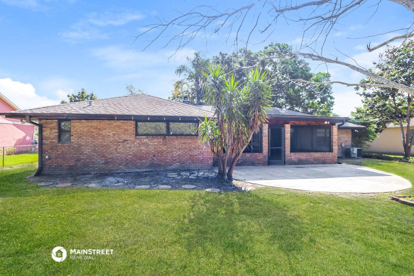 a brick house with a palm tree in front of it