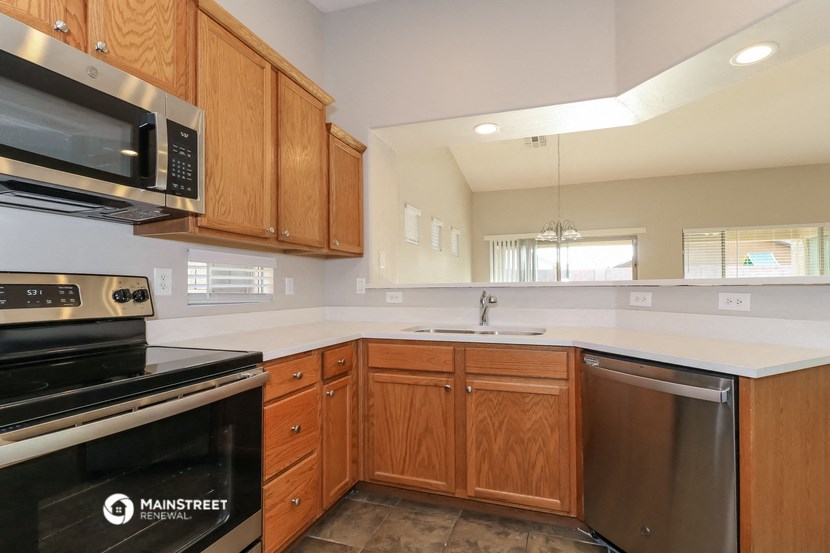a kitchen with wooden cabinets and a stove and a sink