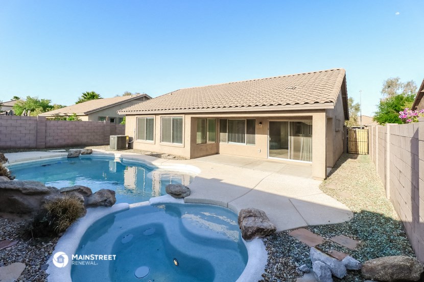 a backyard with a pool and a house