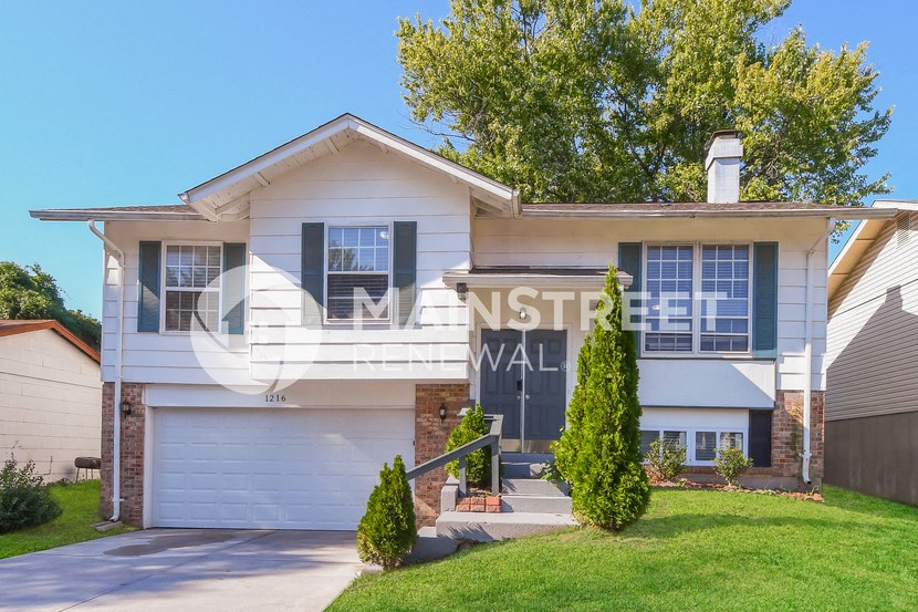 a white house with a sign on the front of it