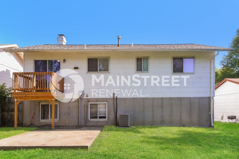 front view of a house with a yard and a deck