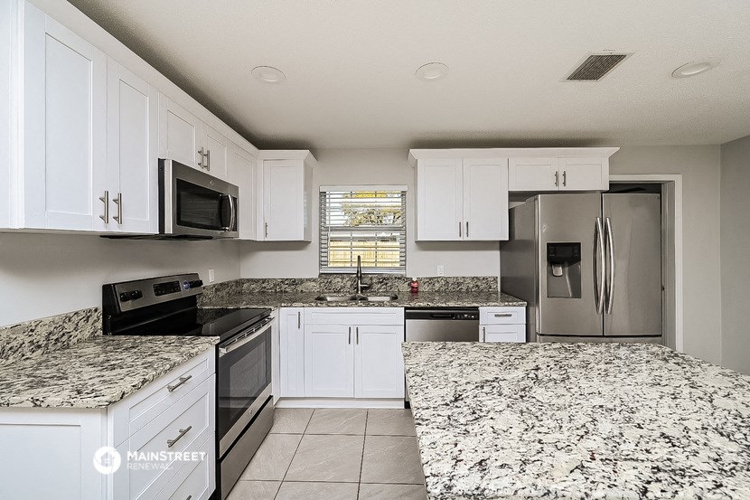 a kitchen with granite counter tops and stainless steel appliances