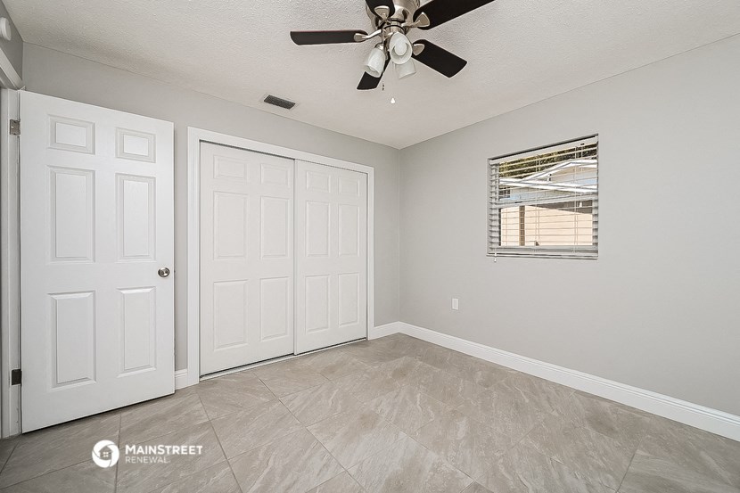 the living room of a home with a ceiling fan