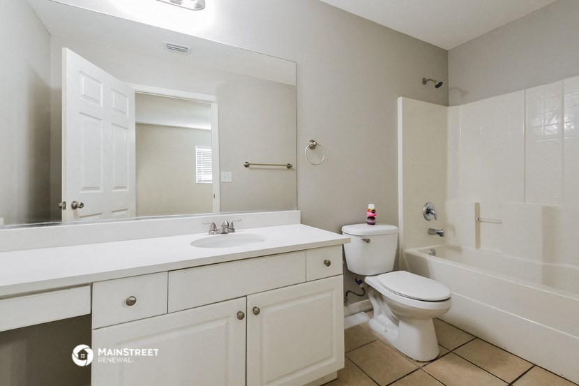 a bathroom with a sink toilet and a tub