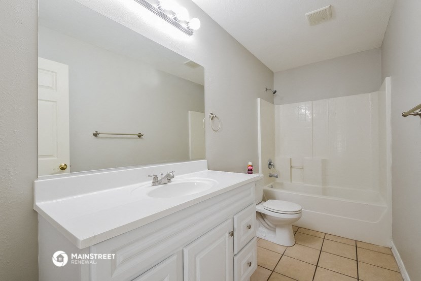 a bathroom with a sink and a toilet and a bath tub