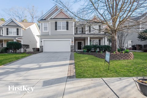 a white house with a driveway and a white garage door