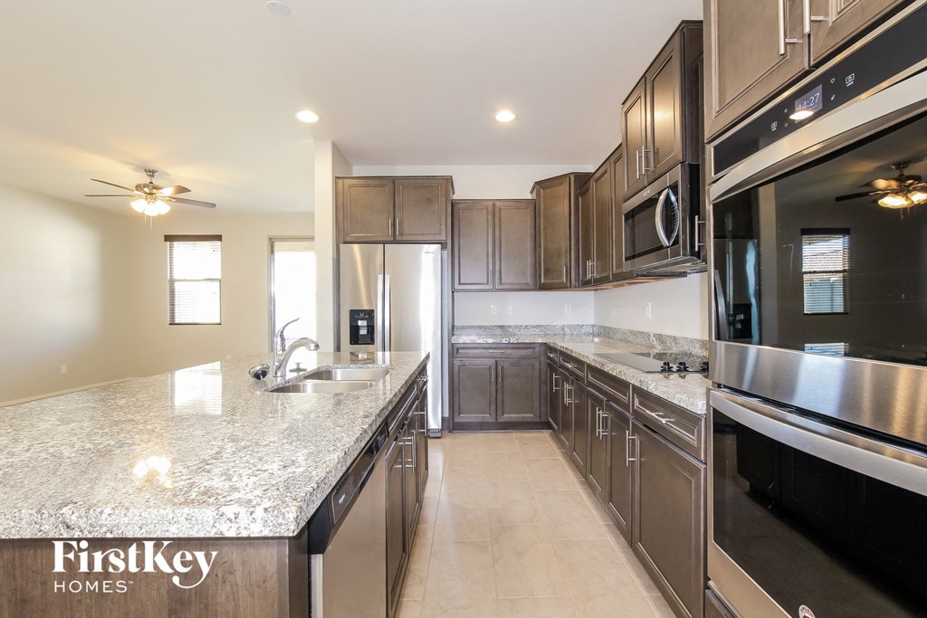 A kitchen with granite countertops and stainless steel appliances.