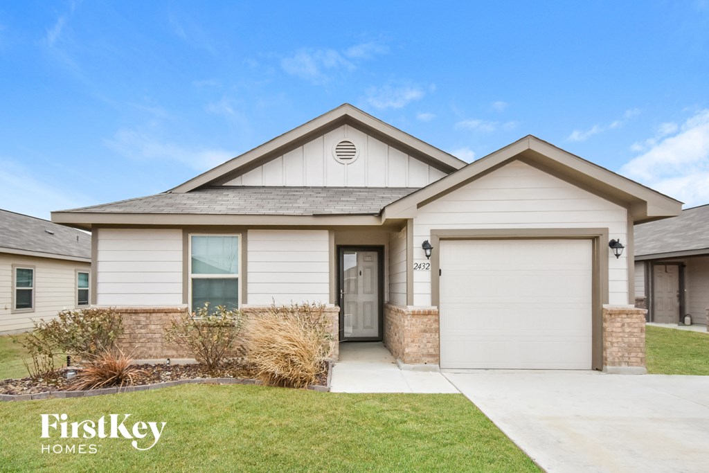a house with a garage door and a lawn