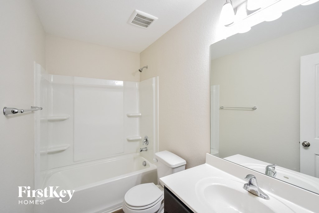 a bathroom with a sink toilet and a bath tub