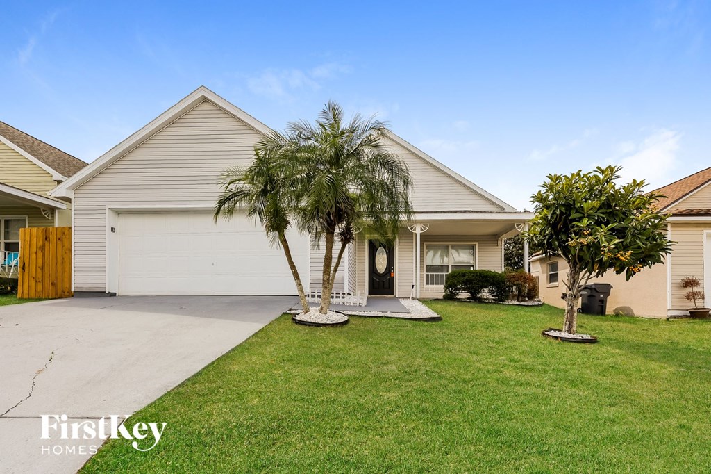 a home with two palm trees in front of it