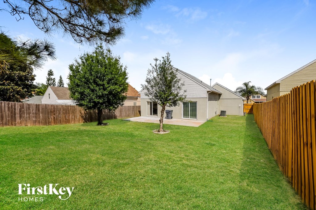 a backyard with a fence and a house
