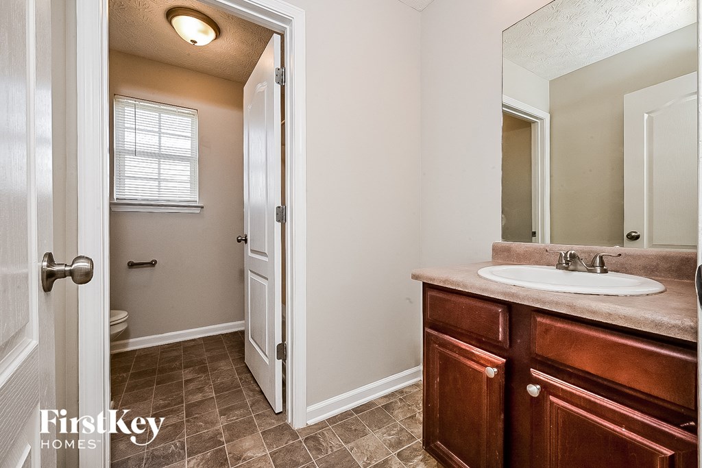 a bathroom with a sink and a mirror and a toilet