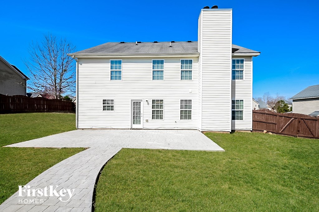 a white house with a walkway in front of it