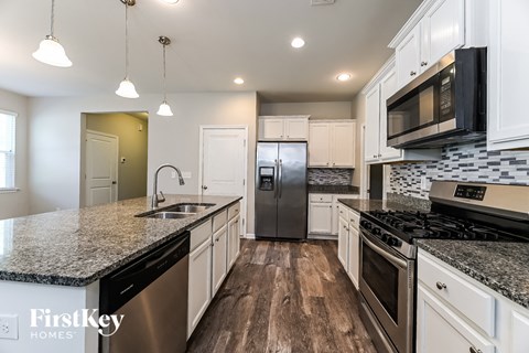 a kitchen with granite counter tops and stainless steel appliances