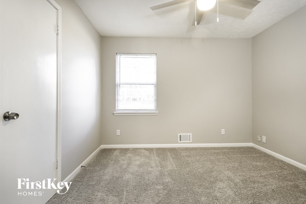 a room with a carpeted floor and a window