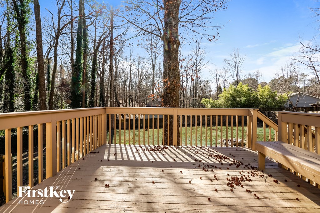 the deck has a view of the trees and the grass