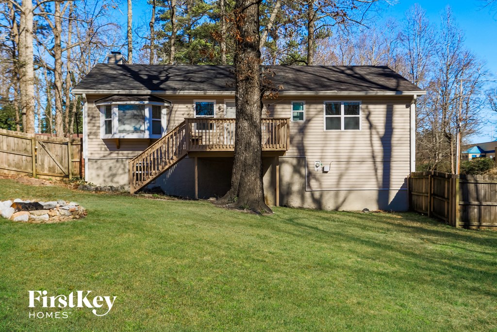 a house with a deck and a tree in the yard
